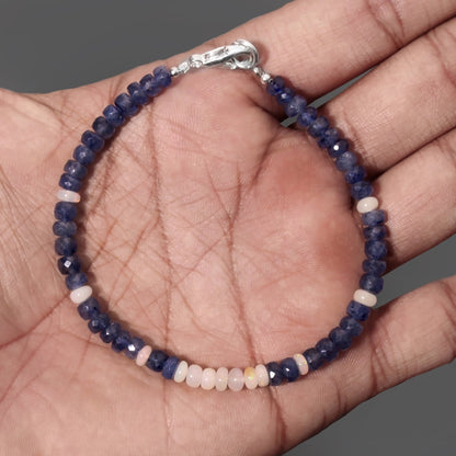 sapphire and opal beaded bracelet close up on hand