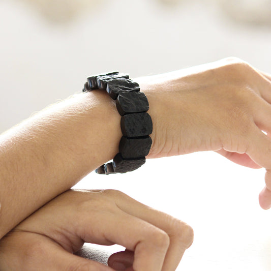 black tektite beaded bracelet on model's hand