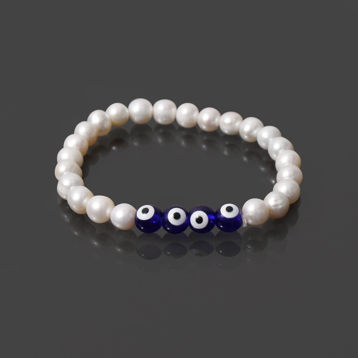 Natural Pearl and evil eye beaded bracelet on grey background