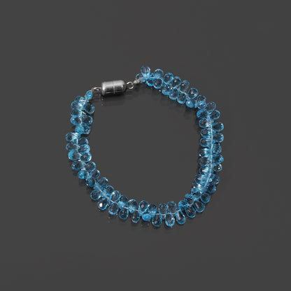 Swiss blue topaz drop beads bracelet with magnetic lock on gray background