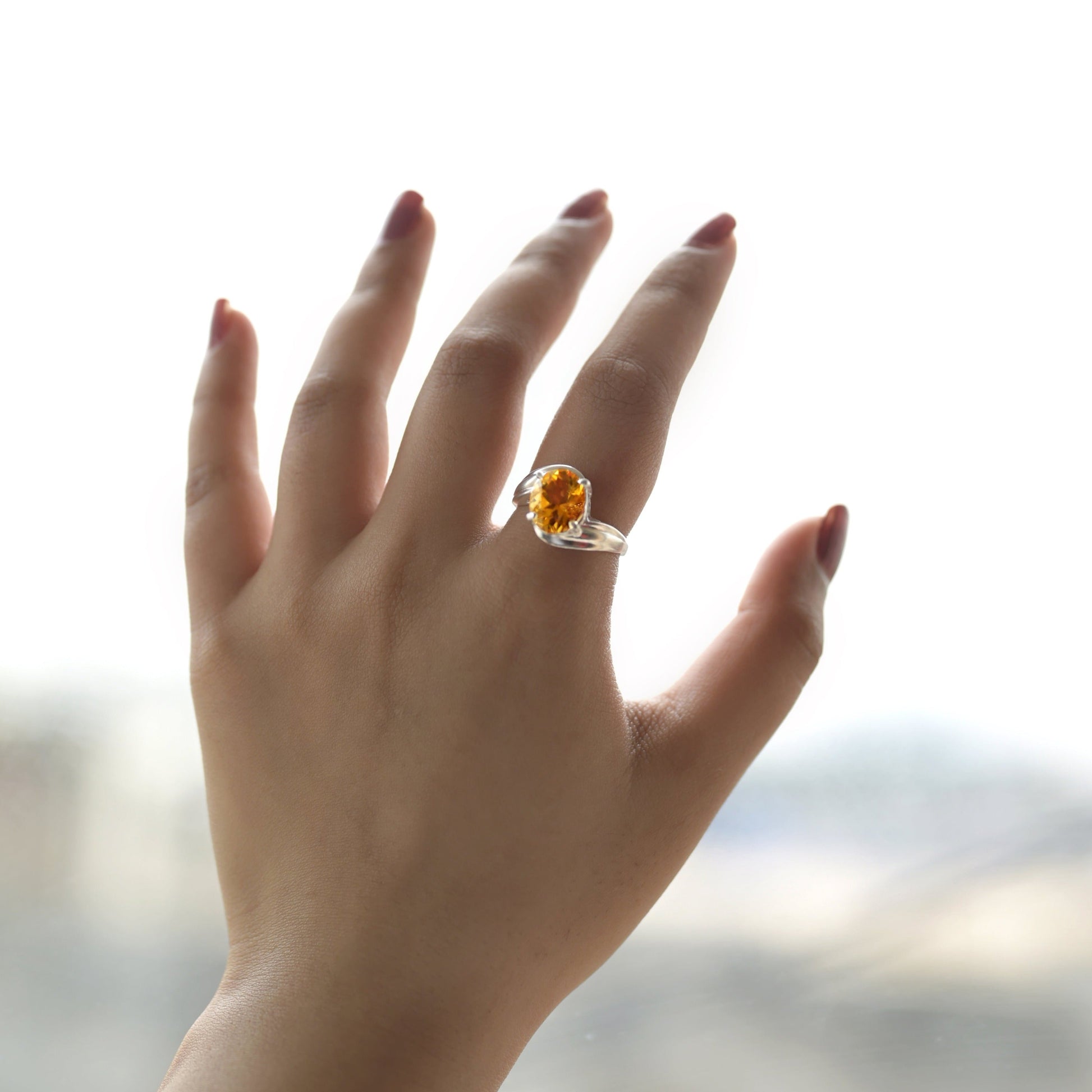 citrine gemstone studded on sterling silver on hand